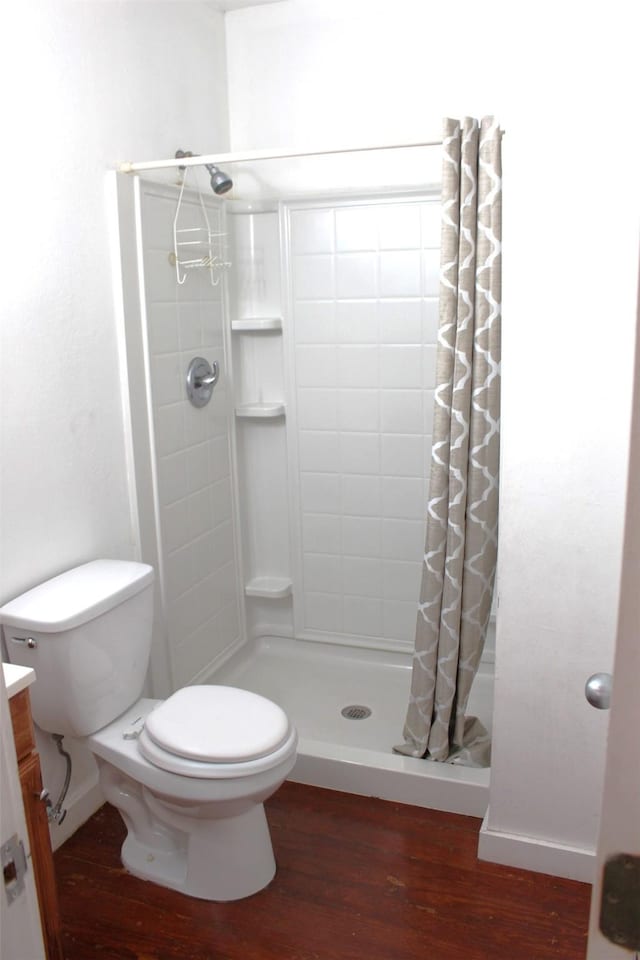 508 Texas St, Brenham, TX 77833 - full bathroom featuring toilet, a stall shower, and wood finished floors