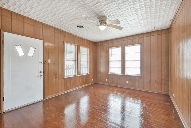 508 Texas St, Brenham, TX 77833 - foyer entrance with wood walls, baseboards, a ceiling fan, and wood-type flooring