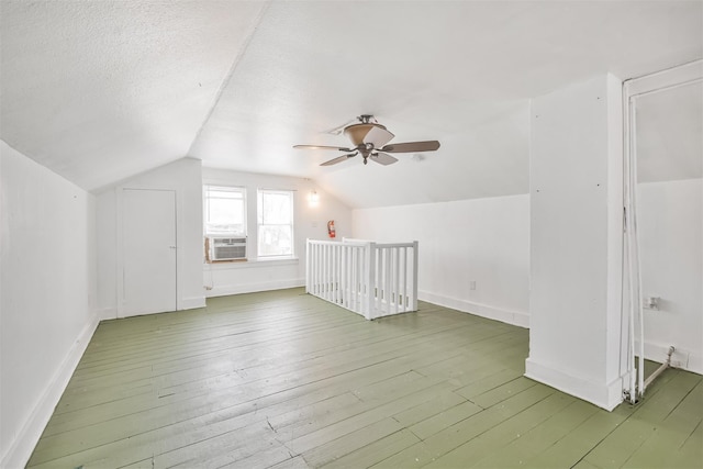 508 Texas St, Brenham, TX 77833 - bonus room with baseboards, cooling unit, ceiling fan, hardwood / wood-style flooring, and vaulted ceiling