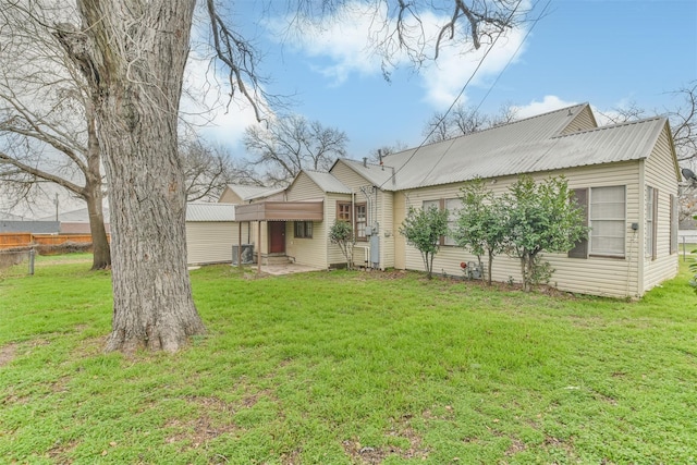 508 Texas St, Brenham, TX 77833 - back of property with a yard, metal roof, and fence