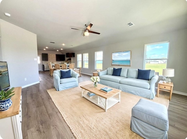 1105 W Bayshore Dr, Palacios, TX 77465 - living area with wood finished floors, visible vents, recessed lighting, ceiling fan, and baseboards