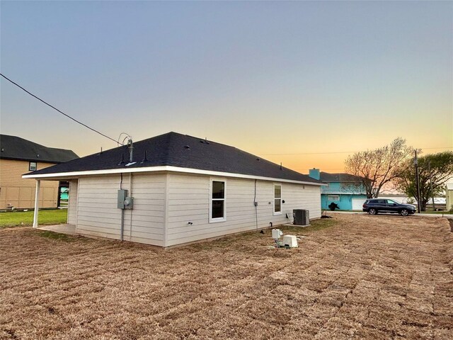 1105 W Bayshore Dr, Palacios, TX 77465 - rear view of house with a yard and central AC unit