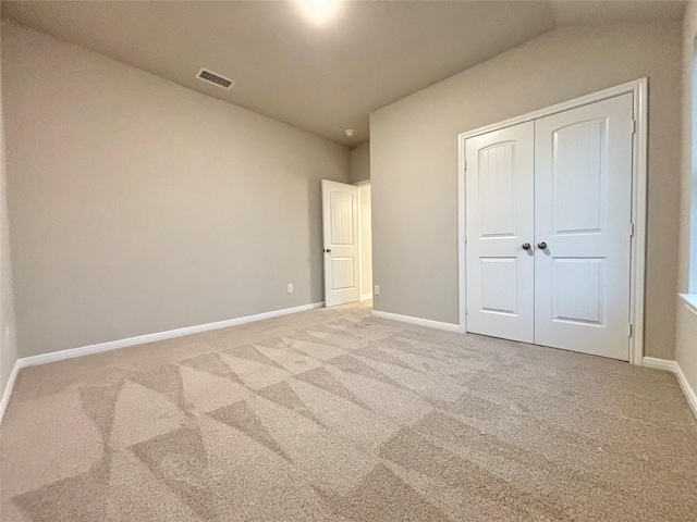1105 W Bayshore Dr, Palacios, TX 77465 - unfurnished bedroom with carpet, baseboards, a closet, and visible vents