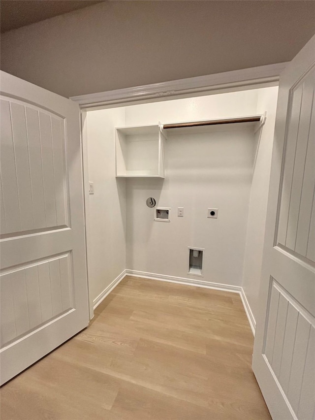 1105 W Bayshore Dr, Palacios, TX 77465 - laundry room with laundry area, light wood-style flooring, electric dryer hookup, washer hookup, and baseboards