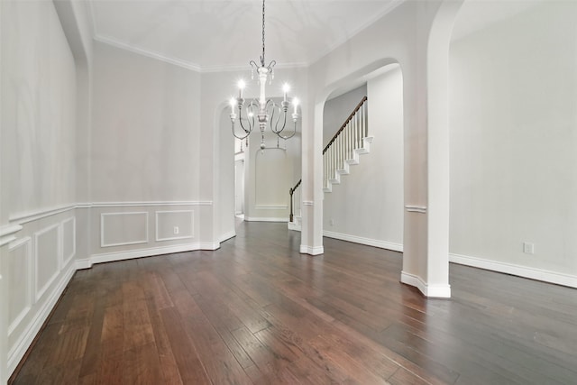 2106 Wild Peregrine Cir, Katy, TX 77494 - unfurnished dining area featuring arched walkways, hardwood / wood-style flooring, crown molding, a chandelier, and stairs