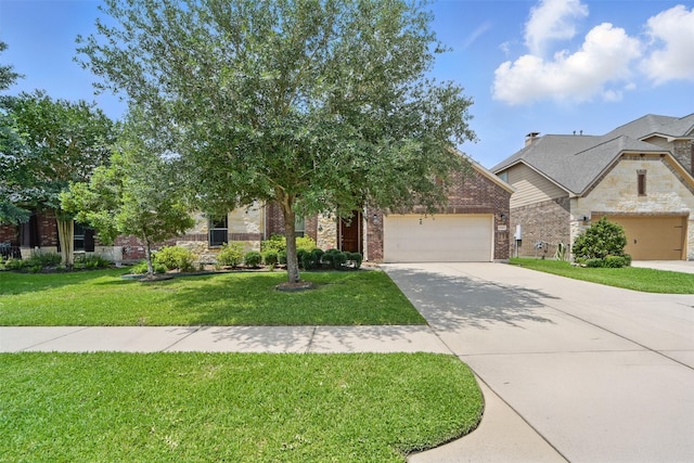 2106 Wild Peregrine Cir, Katy, TX 77494 - view of front of property with driveway, a garage, stone siding, and a front yard