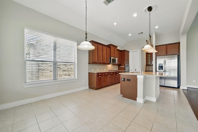 2106 Wild Peregrine Cir, Katy, TX 77494 - kitchen with stainless steel appliances, light countertops, tasteful backsplash, a sink, and a center island with sink