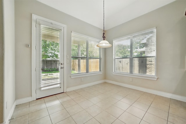 2106 Wild Peregrine Cir, Katy, TX 77494 - unfurnished dining area with light tile patterned floors and baseboards