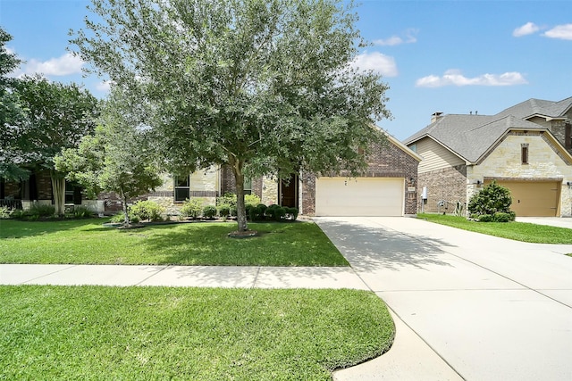 2106 Wild Peregrine Cir, Katy, TX 77494 - view of front of home featuring stone siding, concrete driveway, a front lawn, a garage, and brick siding