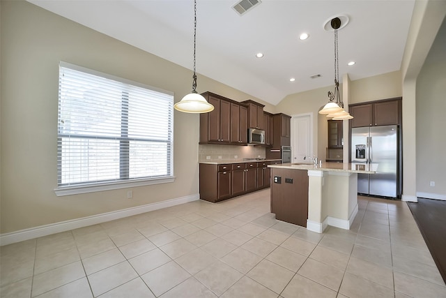 2106 Wild Peregrine Cir, Katy, TX 77494 - kitchen with stainless steel appliances, light countertops, dark brown cabinets, light tile patterned floors, and lofted ceiling