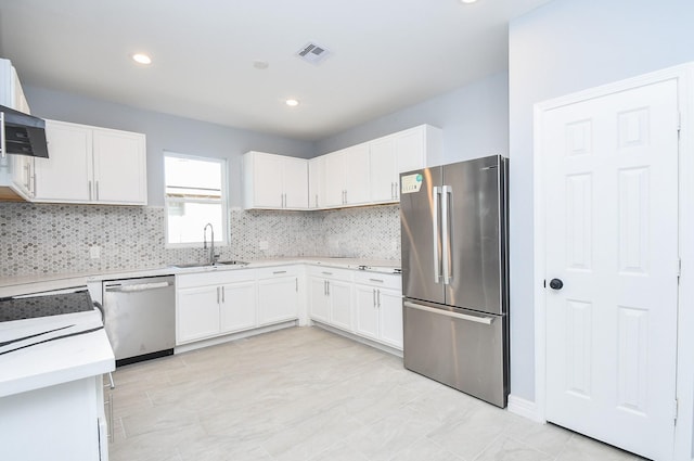 10322 Rancho Bernardo Ln, Sugar Land, TX 77498 - kitchen with a sink, stainless steel appliances, white cabinetry, and visible vents