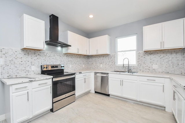10322 Rancho Bernardo Ln, Sugar Land, TX 77498 - kitchen with a sink, stainless steel appliances, tasteful backsplash, wall chimney range hood, and white cabinets