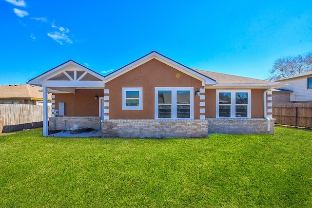 10322 Rancho Bernardo Ln, Sugar Land, TX 77498 - rear view of property with a yard, fence, stucco siding, and brick siding