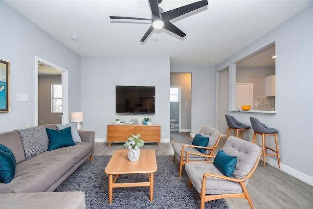 10322 Rancho Bernardo Ln, Sugar Land, TX 77498 - living area with ceiling fan, a wealth of natural light, baseboards, and wood finished floors