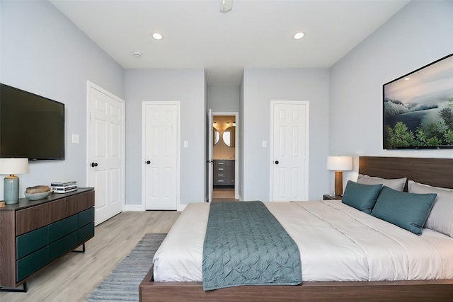 10322 Rancho Bernardo Ln, Sugar Land, TX 77498 - bedroom with baseboards, light wood-style floors, connected bathroom, and recessed lighting