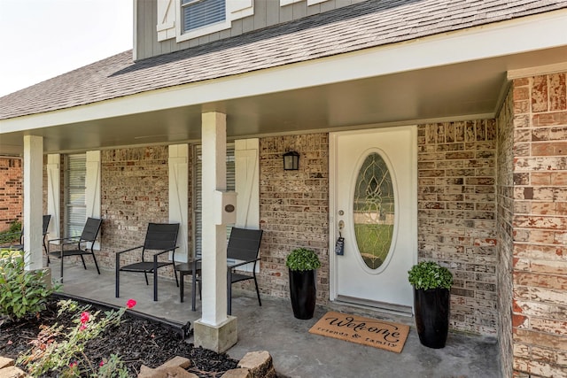 1865 El Mar Ln, Seabrook, TX 77586 - property entrance featuring a porch, brick siding, and roof with shingles