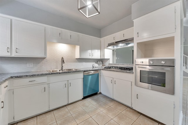 1865 El Mar Ln, Seabrook, TX 77586 - kitchen with appliances with stainless steel finishes, a sink, under cabinet range hood, light tile patterned floors, and white cabinetry