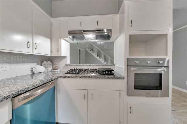 1865 El Mar Ln, Seabrook, TX 77586 - kitchen featuring appliances with stainless steel finishes, under cabinet range hood, white cabinets, and light tile patterned floors