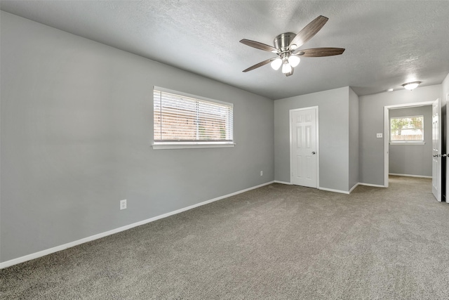 1865 El Mar Ln, Seabrook, TX 77586 - unfurnished bedroom with a textured ceiling, carpet flooring, baseboards, and ceiling fan