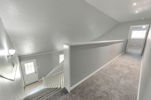 1865 El Mar Ln, Seabrook, TX 77586 - corridor with a textured ceiling, carpet, baseboards, and vaulted ceiling