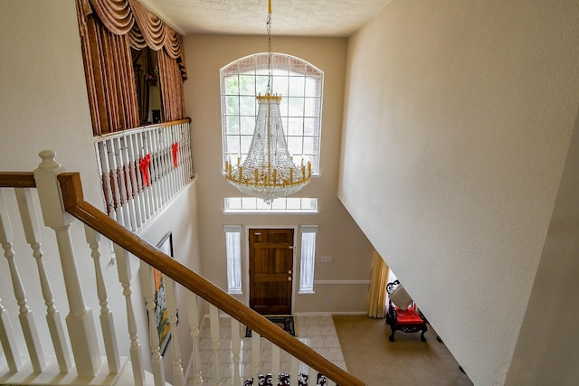 3222 Mossy Elm Ct, Houston, TX 77059 - foyer entrance featuring a chandelier, stairs, carpet, and baseboards