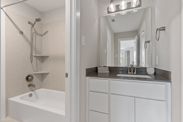 full bathroom featuring visible vents, vanity, and shower / bathtub combination