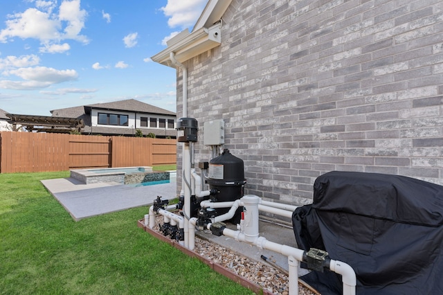 view of yard with a patio, an in ground hot tub, and a fenced backyard