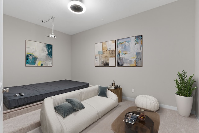 carpeted living area with baseboards