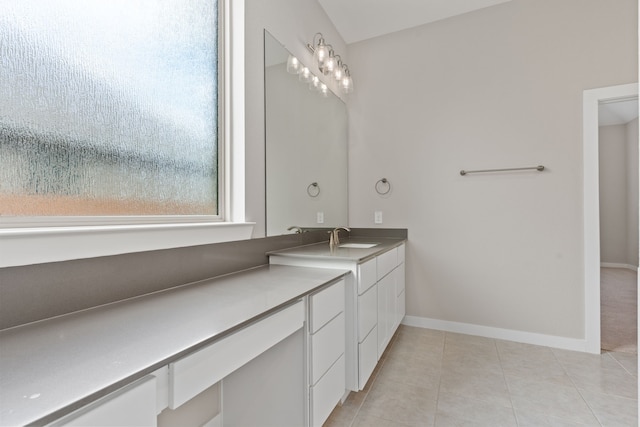 bathroom featuring baseboards, tile patterned floors, and vanity