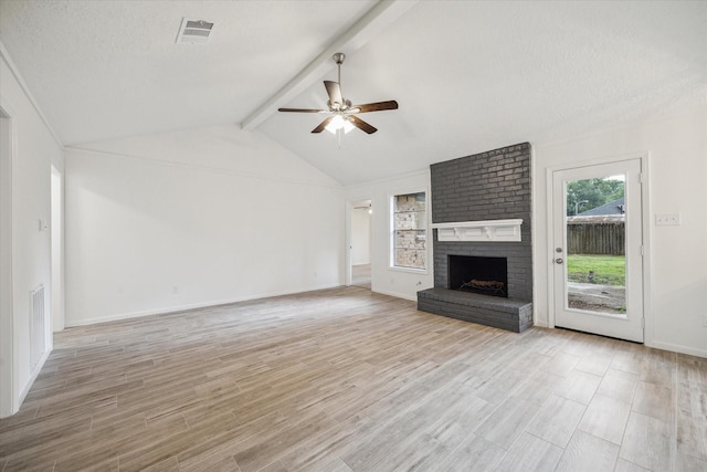 unfurnished living room featuring a fireplace, light wood finished floors, a ceiling fan, and visible vents