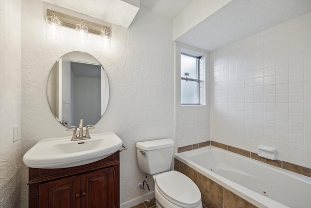 bathroom featuring vanity, toilet, and a textured wall
