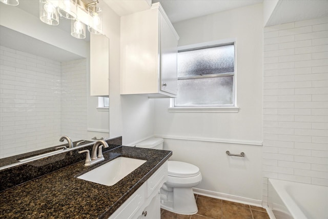 bathroom with toilet, baseboards, tile patterned flooring, and vanity