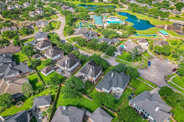 birds eye view of property with a water view and a residential view