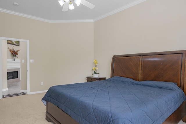 carpeted bedroom with a ceiling fan, a fireplace, baseboards, and ornamental molding