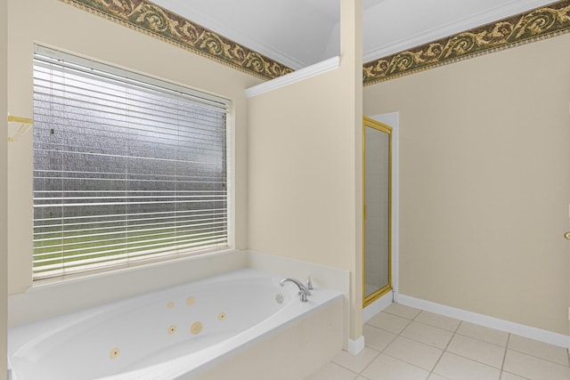 full bath featuring a stall shower, a jetted tub, baseboards, and tile patterned floors