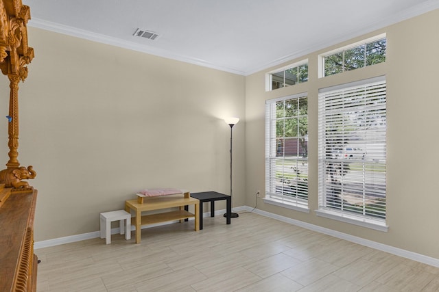 interior space featuring visible vents, baseboards, and ornamental molding