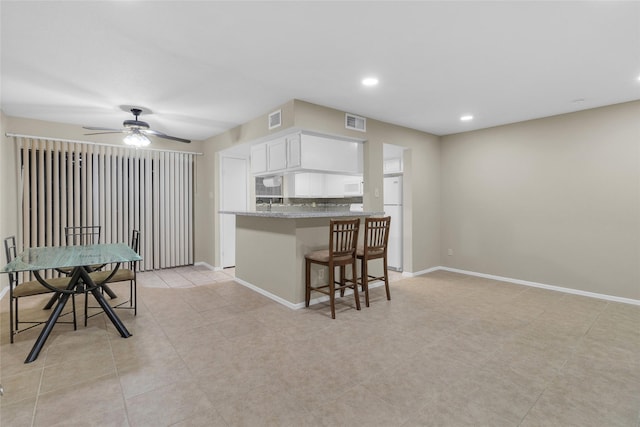 14911 Wunderlich Dr Unit 609, Houston, TX 77069 - kitchen with white cabinetry, visible vents, ceiling fan, and white appliances