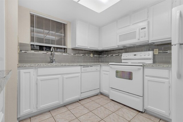 14911 Wunderlich Dr Unit 609, Houston, TX 77069 - kitchen featuring a sink, white appliances, light tile patterned flooring, decorative backsplash, and white cabinets