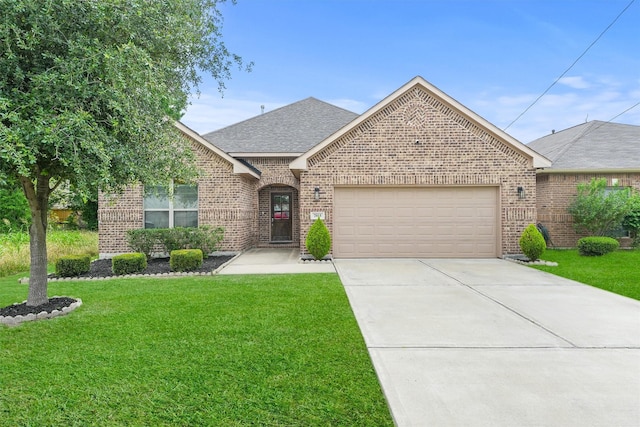view of front facade featuring an attached garage, brick siding, driveway, a front lawn, and a shingled roof