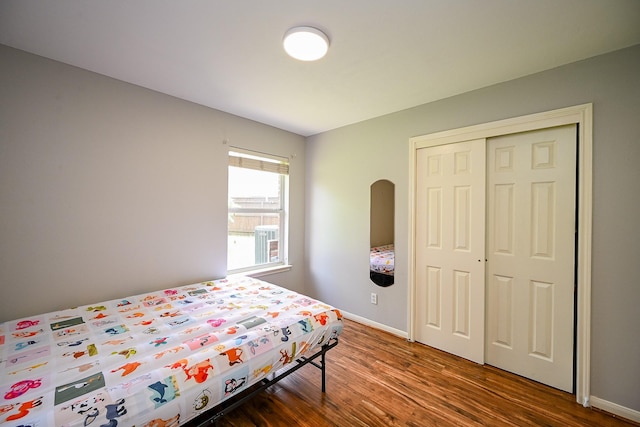 21111 Diamond Rock Ct, Katy, TX 77449 - bedroom featuring wood finished floors, a closet, and baseboards