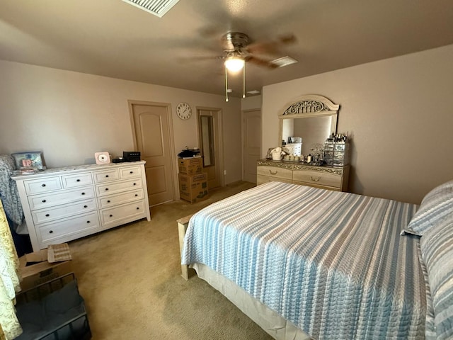 bedroom featuring light colored carpet, ceiling fan, and visible vents