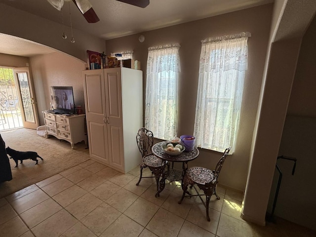dining area featuring light tile patterned floors and ceiling fan