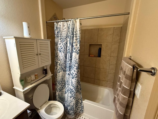 full bath with toilet, vanity, shower / bath combination with curtain, and a textured wall