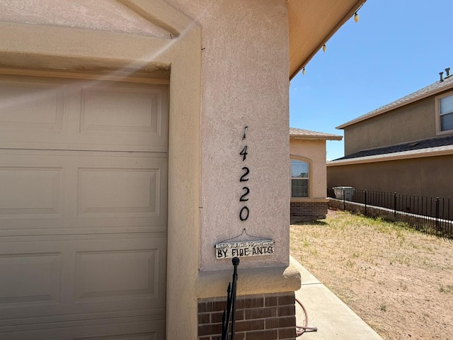 exterior details with fence and stucco siding