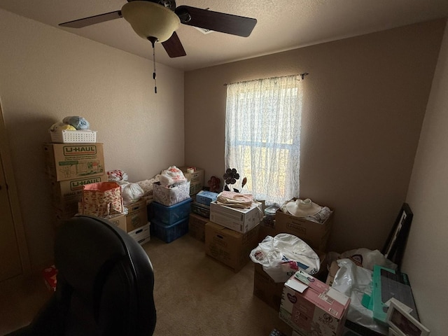 interior space featuring ceiling fan and carpet floors