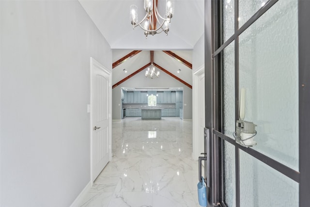 hall featuring vaulted ceiling, a notable chandelier, baseboards, and marble finish floor