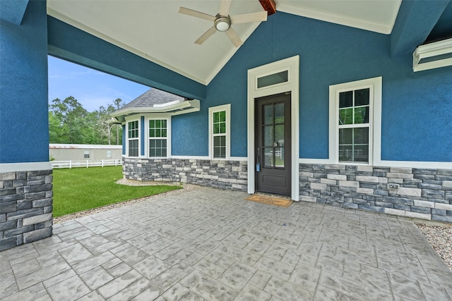 view of patio featuring ceiling fan and fence