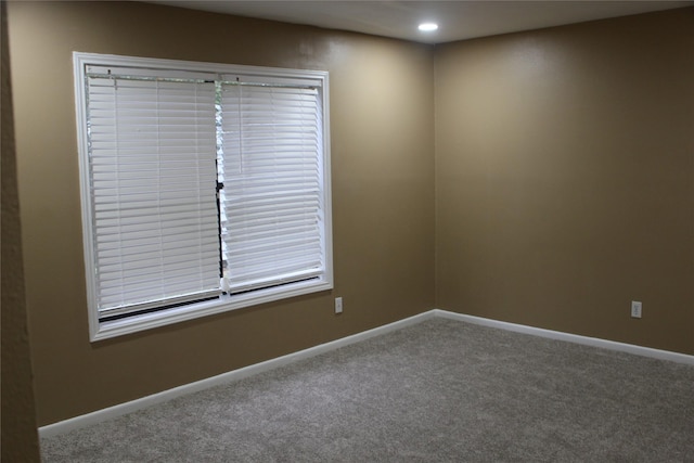 carpeted empty room featuring baseboards and recessed lighting