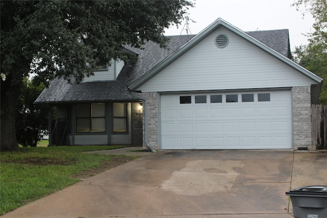 view of front of property featuring driveway, brick siding, a shingled roof, and an attached garage