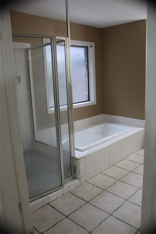 full bathroom with a stall shower, tile patterned floors, and a bath